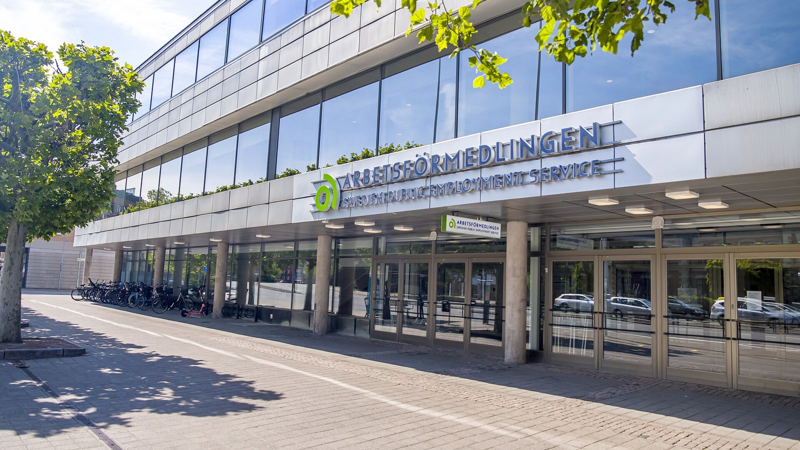Entrén till Arbetsförmedlingens kontor i Malmö med skylten Arbetsförmedlingen – Swedish Public Employment Service ovanför glasdörrarna